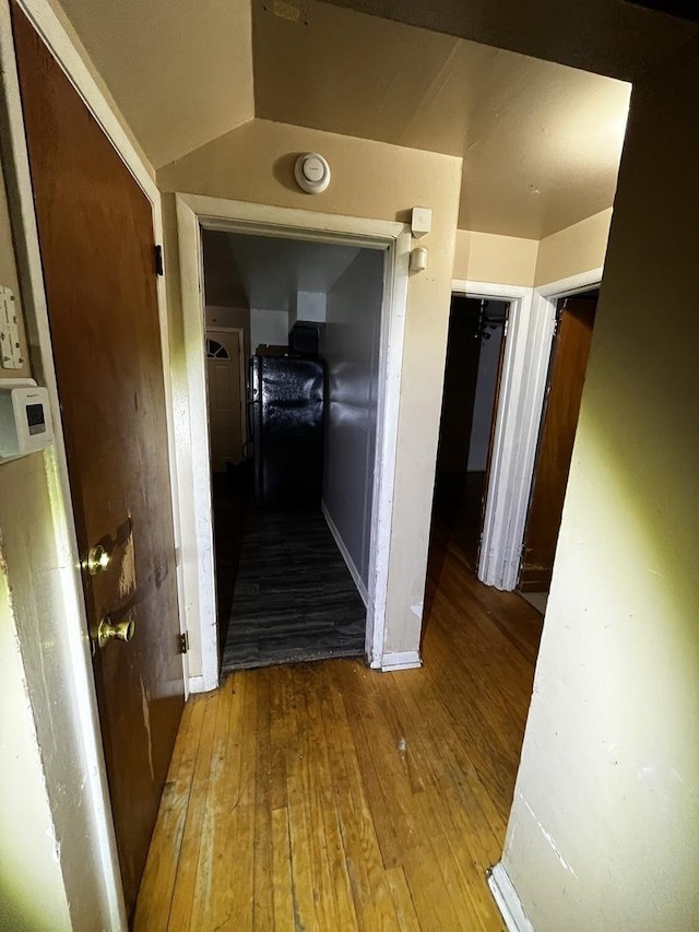 hallway with hardwood / wood-style flooring