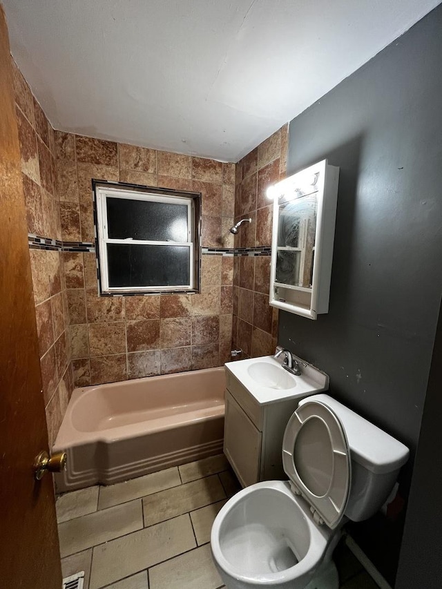 full bathroom with tiled shower / bath combo, toilet, and vanity