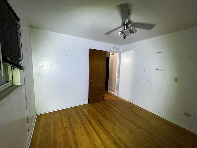 unfurnished bedroom with ceiling fan and wood-type flooring