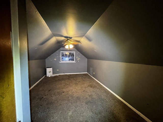 bonus room with vaulted ceiling and carpet