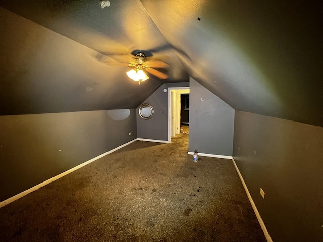 additional living space featuring vaulted ceiling and carpet