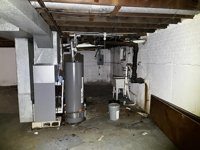 utility room featuring sink, gas water heater, electric panel, and heating unit