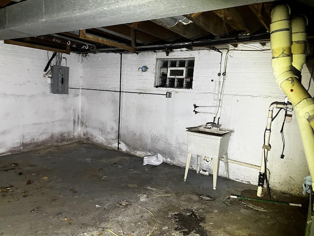 basement featuring sink and electric panel