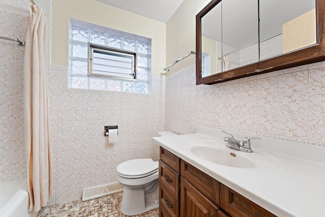 full bathroom with vanity, tile walls, shower / bath combo, and toilet