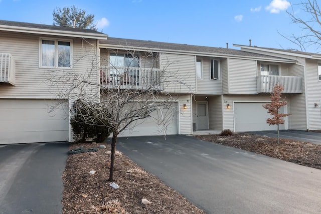 multi unit property with a balcony and a garage