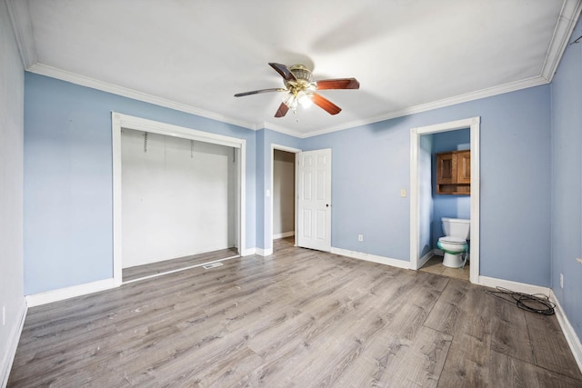 unfurnished bedroom with ensuite bath, light hardwood / wood-style floors, a closet, ceiling fan, and crown molding