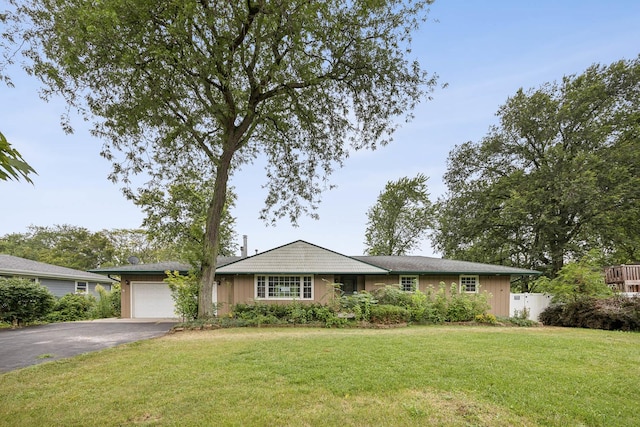 ranch-style home with a front yard and a garage