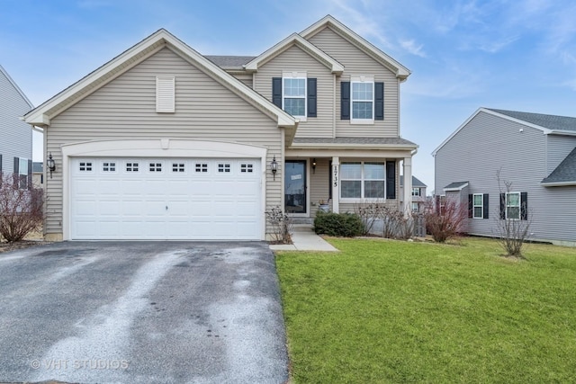 view of front of house featuring a garage and a front yard