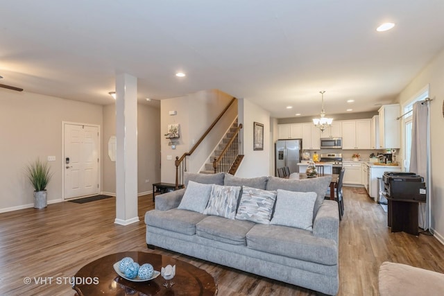 living room with a chandelier and light hardwood / wood-style floors