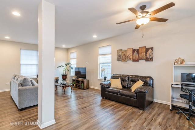 living room featuring wood-type flooring and ceiling fan