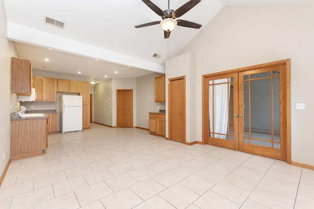 kitchen with light tile patterned flooring, high vaulted ceiling, white fridge, ceiling fan, and french doors