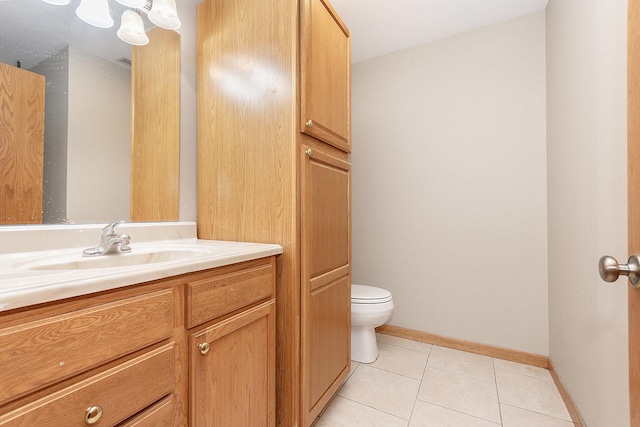 bathroom with vanity, toilet, and tile patterned flooring