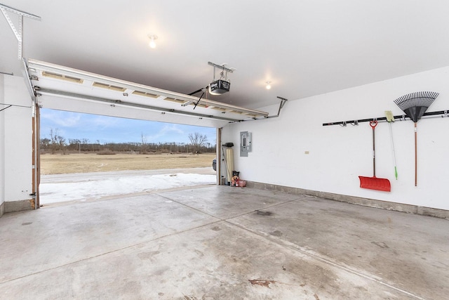 garage with a garage door opener and electric panel