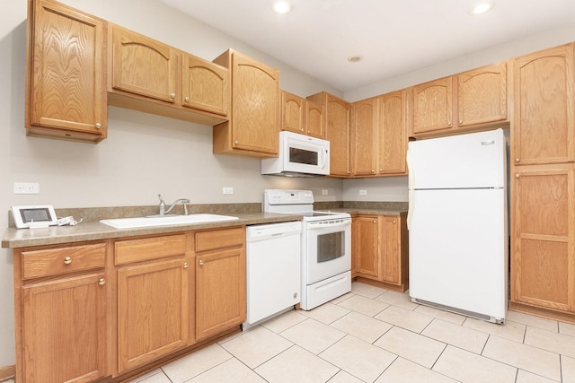 kitchen featuring light tile patterned flooring, white appliances, and sink