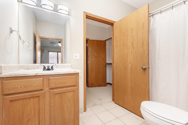 bathroom featuring ceiling fan, vanity, toilet, and tile patterned flooring