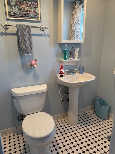 bathroom with toilet and tile patterned flooring