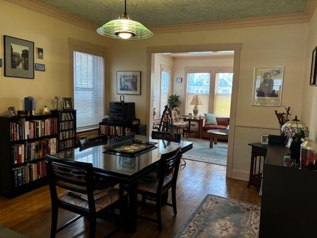 dining area featuring crown molding and dark hardwood / wood-style floors