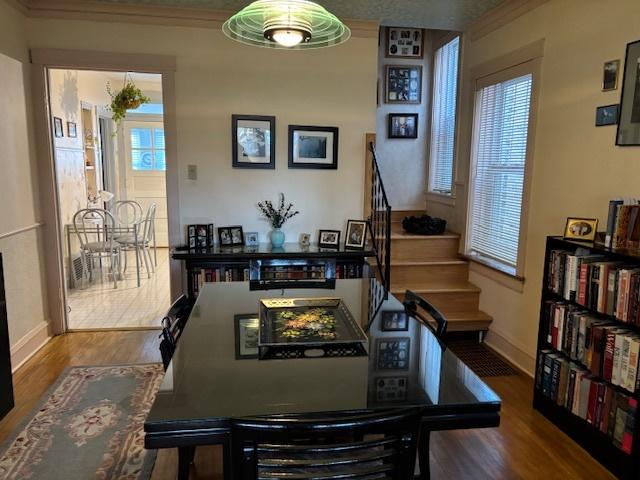 dining room featuring wood-type flooring and ornamental molding