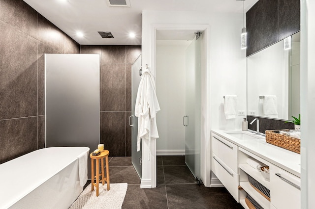 bathroom featuring vanity, separate shower and tub, and tile walls