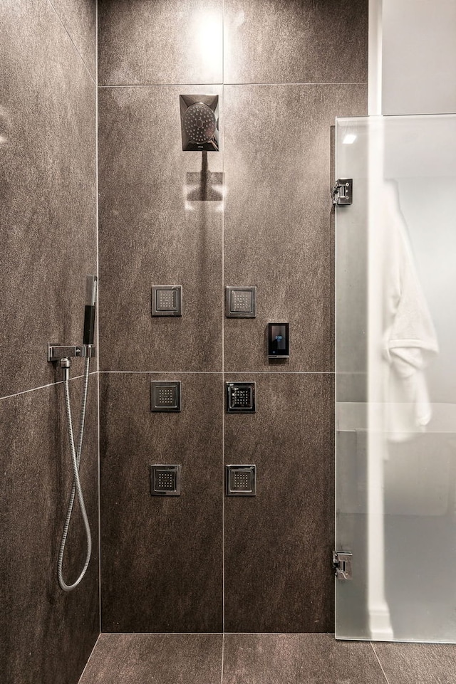 bathroom with a tile shower