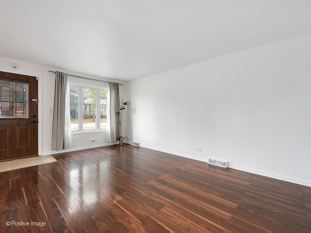 spare room featuring dark hardwood / wood-style flooring