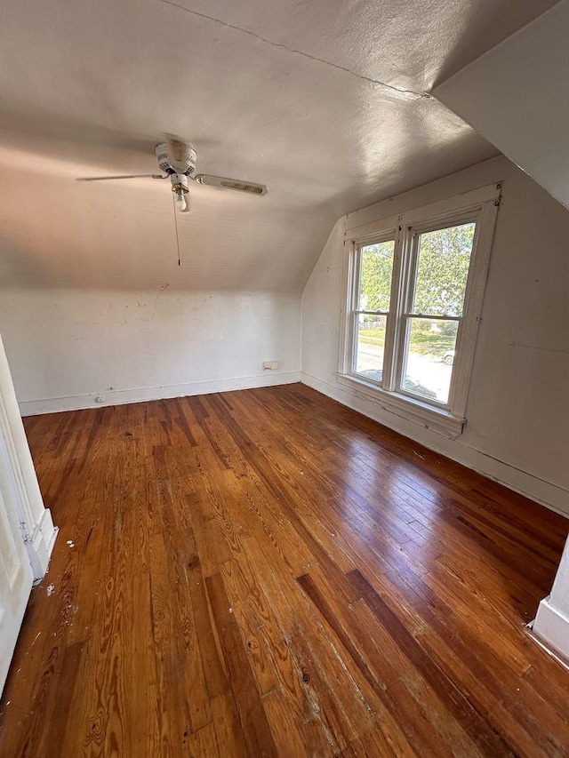 additional living space featuring ceiling fan, hardwood / wood-style floors, a textured ceiling, and vaulted ceiling