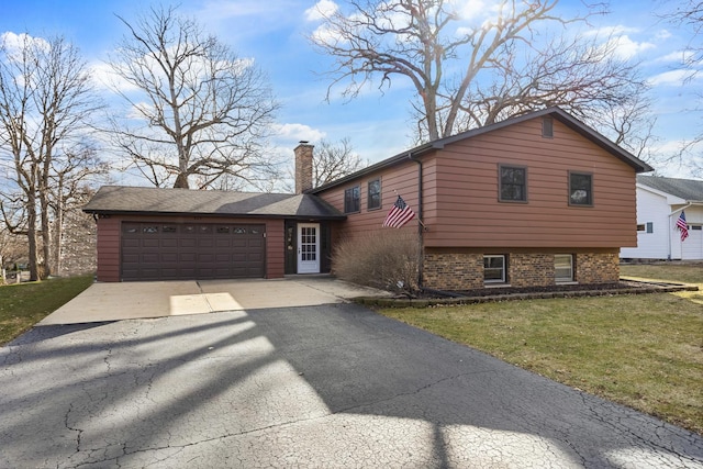 tri-level home with a garage, a front yard, driveway, and a chimney