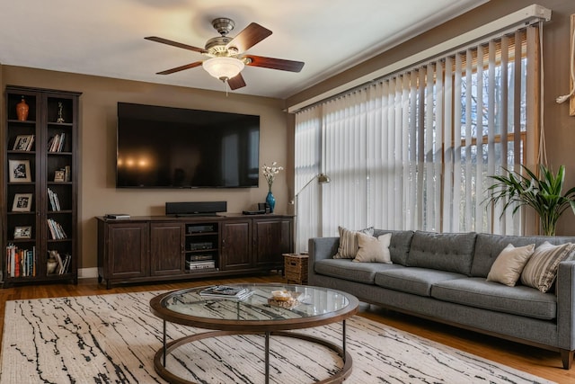 living room with ceiling fan and wood finished floors