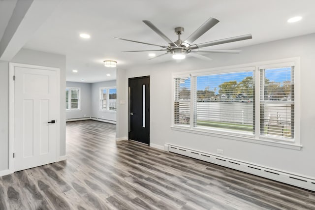 interior space featuring a baseboard radiator, hardwood / wood-style floors, and ceiling fan