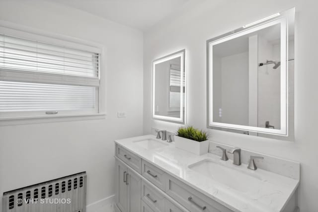 bathroom with radiator heating unit and vanity