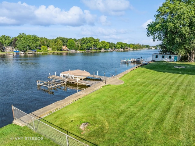 dock area with a water view and a yard