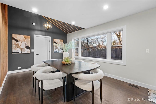 dining area featuring an inviting chandelier and dark hardwood / wood-style flooring