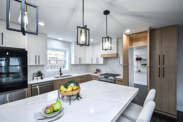 kitchen with stainless steel appliances, a sink, white cabinets, open shelves, and tasteful backsplash