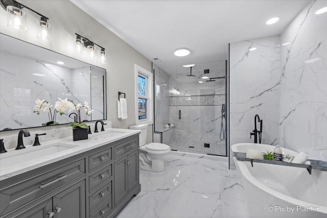 bathroom featuring marble finish floor, a marble finish shower, a sink, and a soaking tub