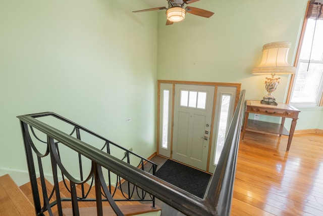 entrance foyer featuring ceiling fan, a healthy amount of sunlight, and light hardwood / wood-style flooring