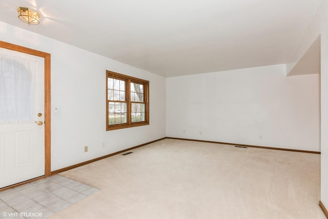 unfurnished room with light carpet, baseboards, and visible vents