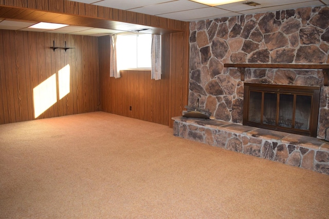 unfurnished living room with wooden walls and carpet flooring