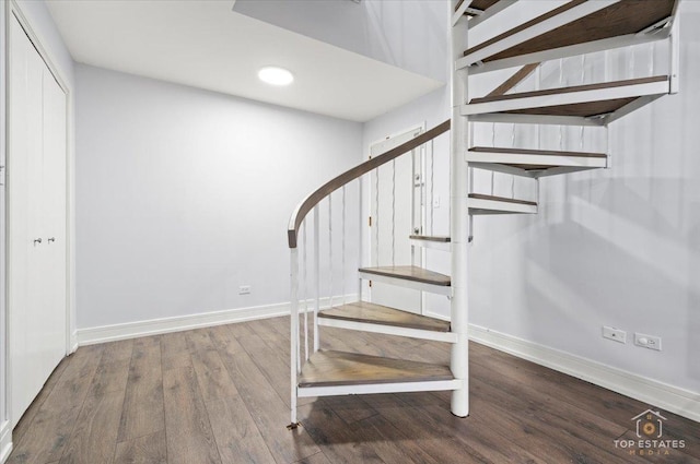 staircase with hardwood / wood-style floors