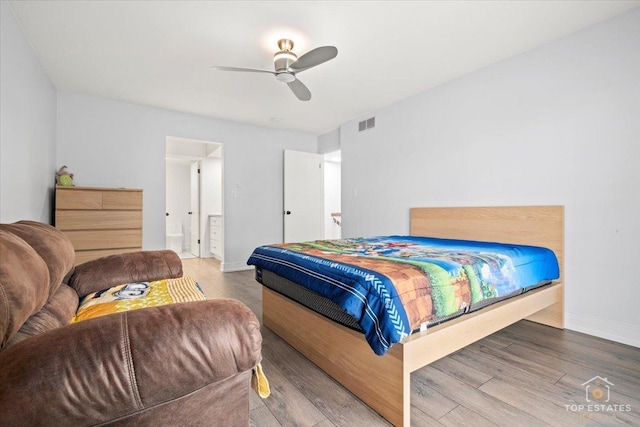 bedroom with ceiling fan, ensuite bathroom, and hardwood / wood-style floors