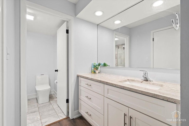 bathroom featuring vanity, toilet, and tile patterned floors