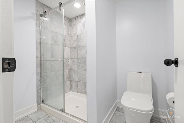 bathroom featuring toilet and an enclosed shower