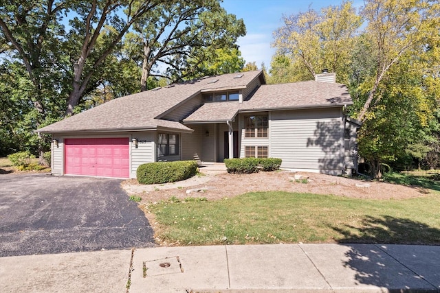 view of front of property featuring a garage and a front lawn