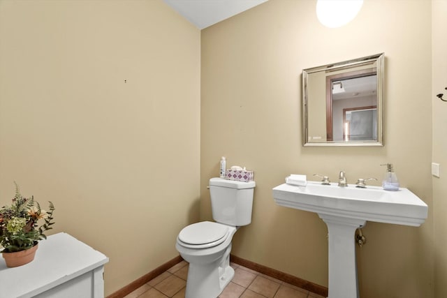 bathroom with toilet and tile patterned flooring