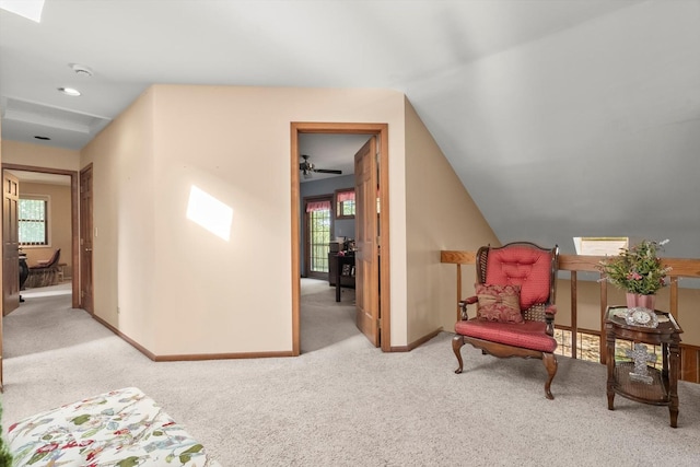 living area featuring light colored carpet and lofted ceiling