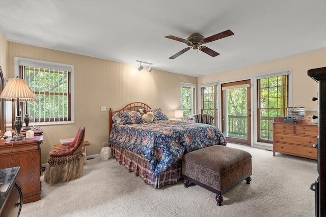 bedroom with light colored carpet, access to exterior, and ceiling fan