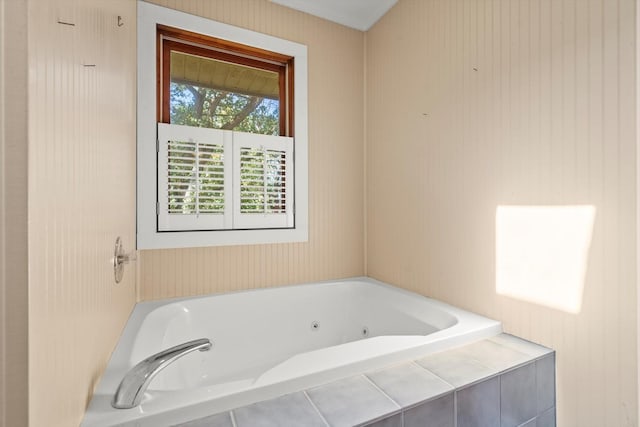 bathroom with a relaxing tiled tub