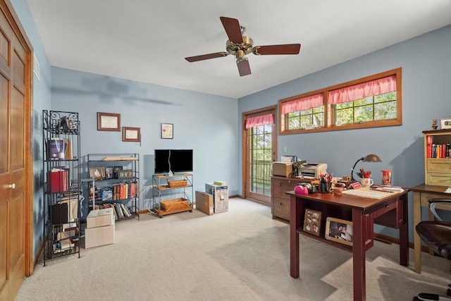 carpeted office space featuring ceiling fan