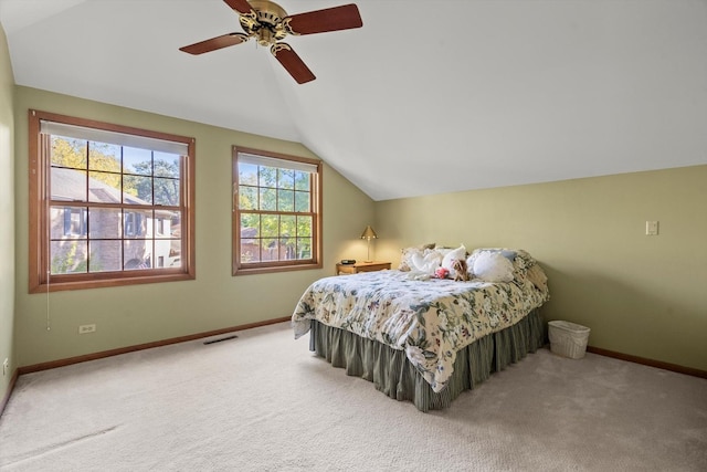 carpeted bedroom with ceiling fan and lofted ceiling