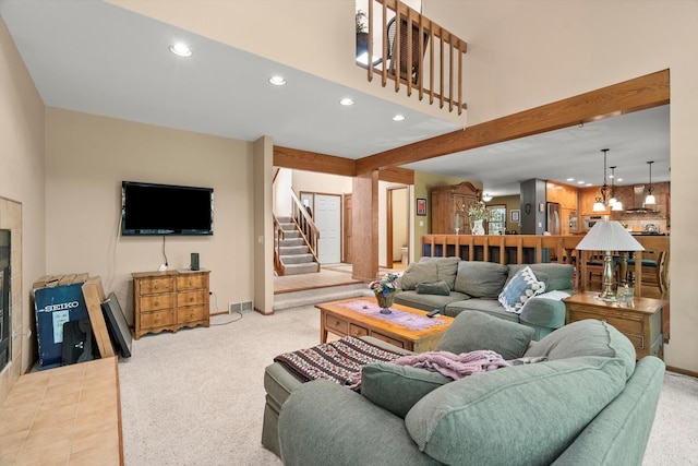 living room featuring light carpet and beamed ceiling