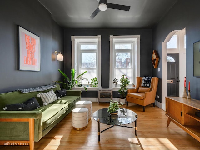 living area featuring light hardwood / wood-style floors and ceiling fan